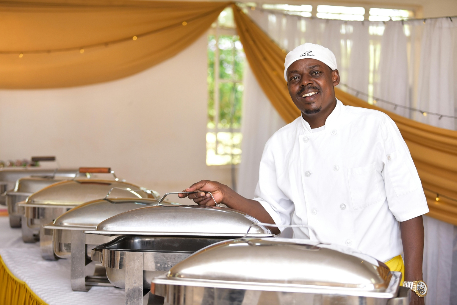 Nairobi hotel buffet chef standing by bain marie service line