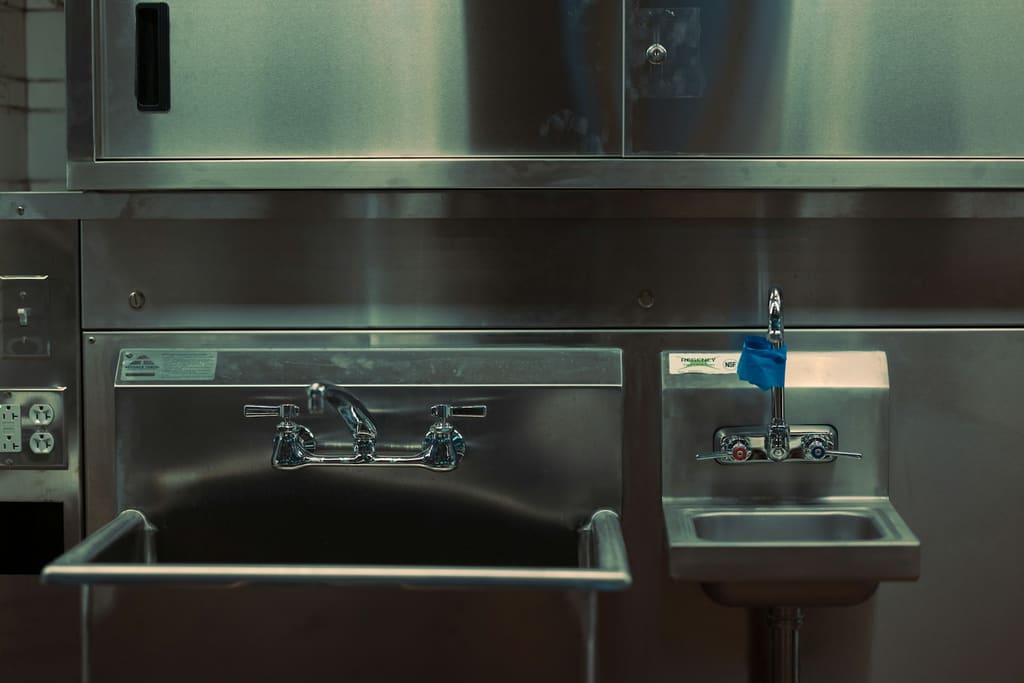 Stainless steel commercial kitchen with washing sink station